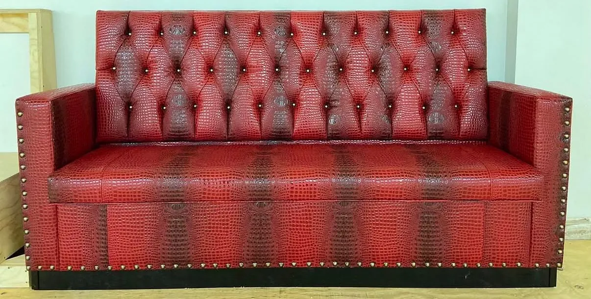 Red croc-embossed vinyl bench with diamond-tufted back and nailhead trim